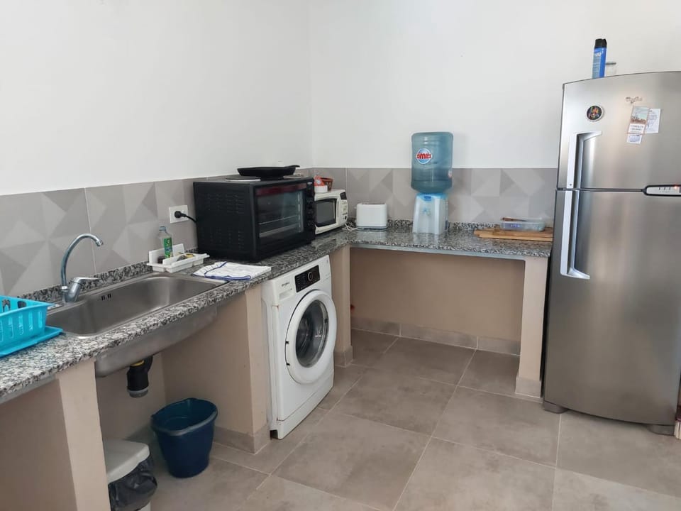 Kitchen or kitchenette, oven, stove, toaster, washing machine