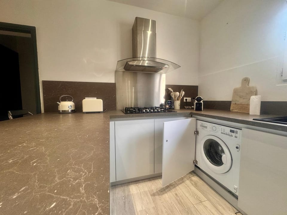 Kitchen or kitchenette, dishwasher, oven, stove, washing machine