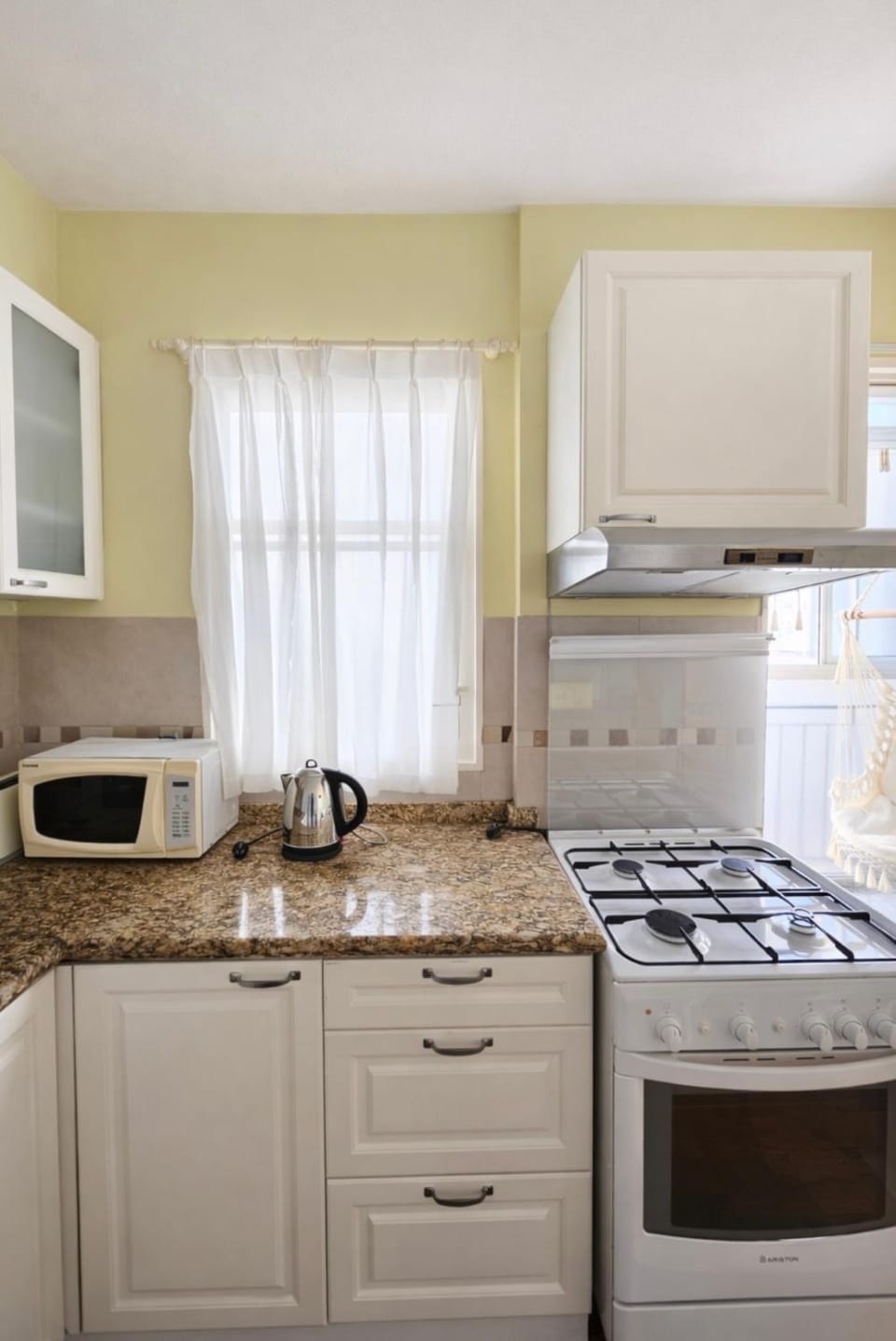 Kitchen or kitchenette, microwave, stove, toaster