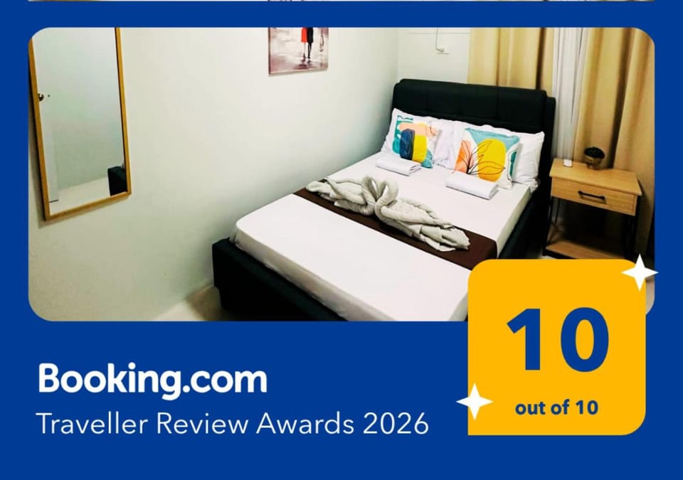 Bed, Property logo or sign, Photo of the whole room, Logo/Certificate/Sign, Bedroom, Text overlay, Certificate/Award, towels