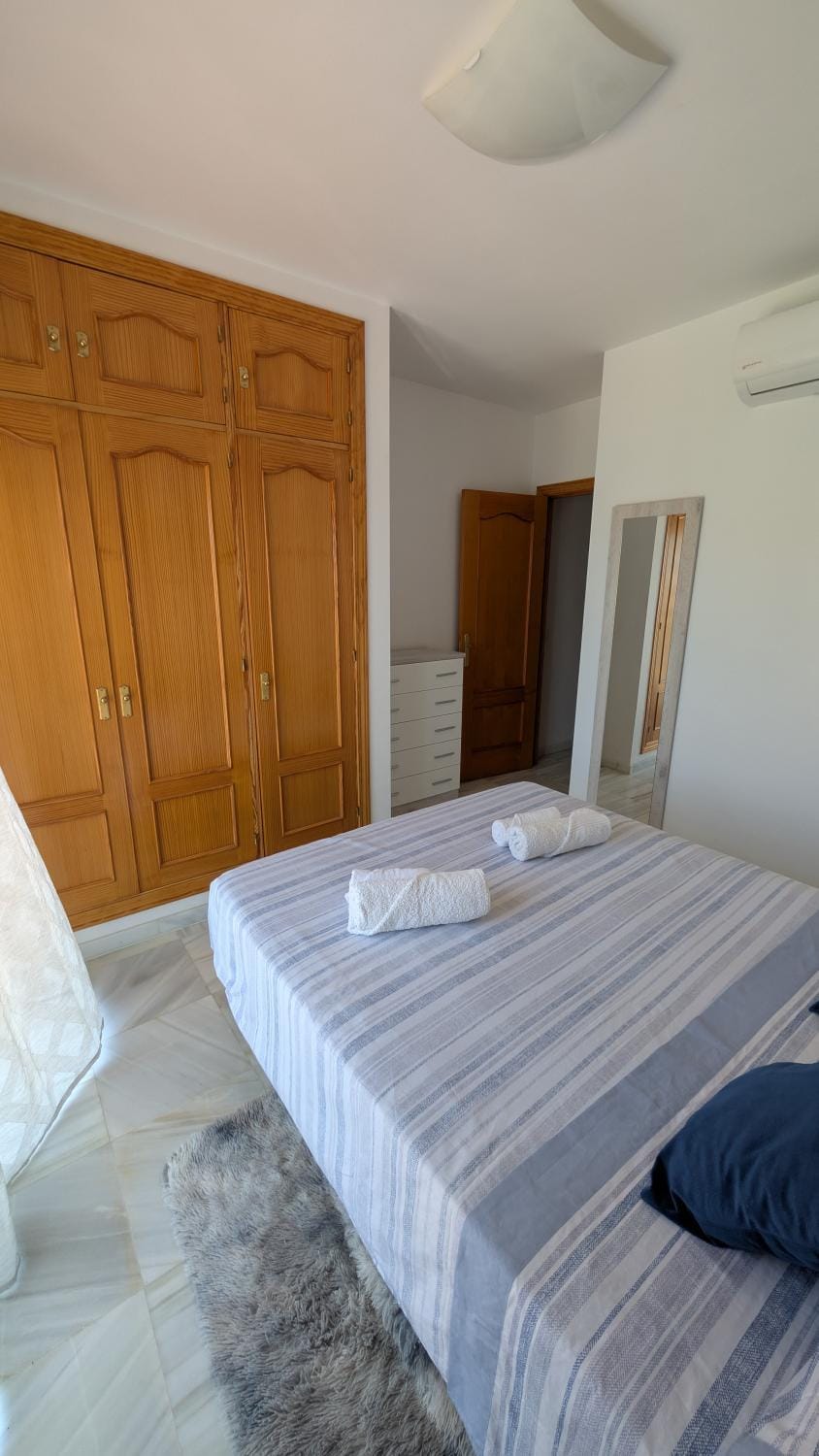 Bed, towels, wardrobe