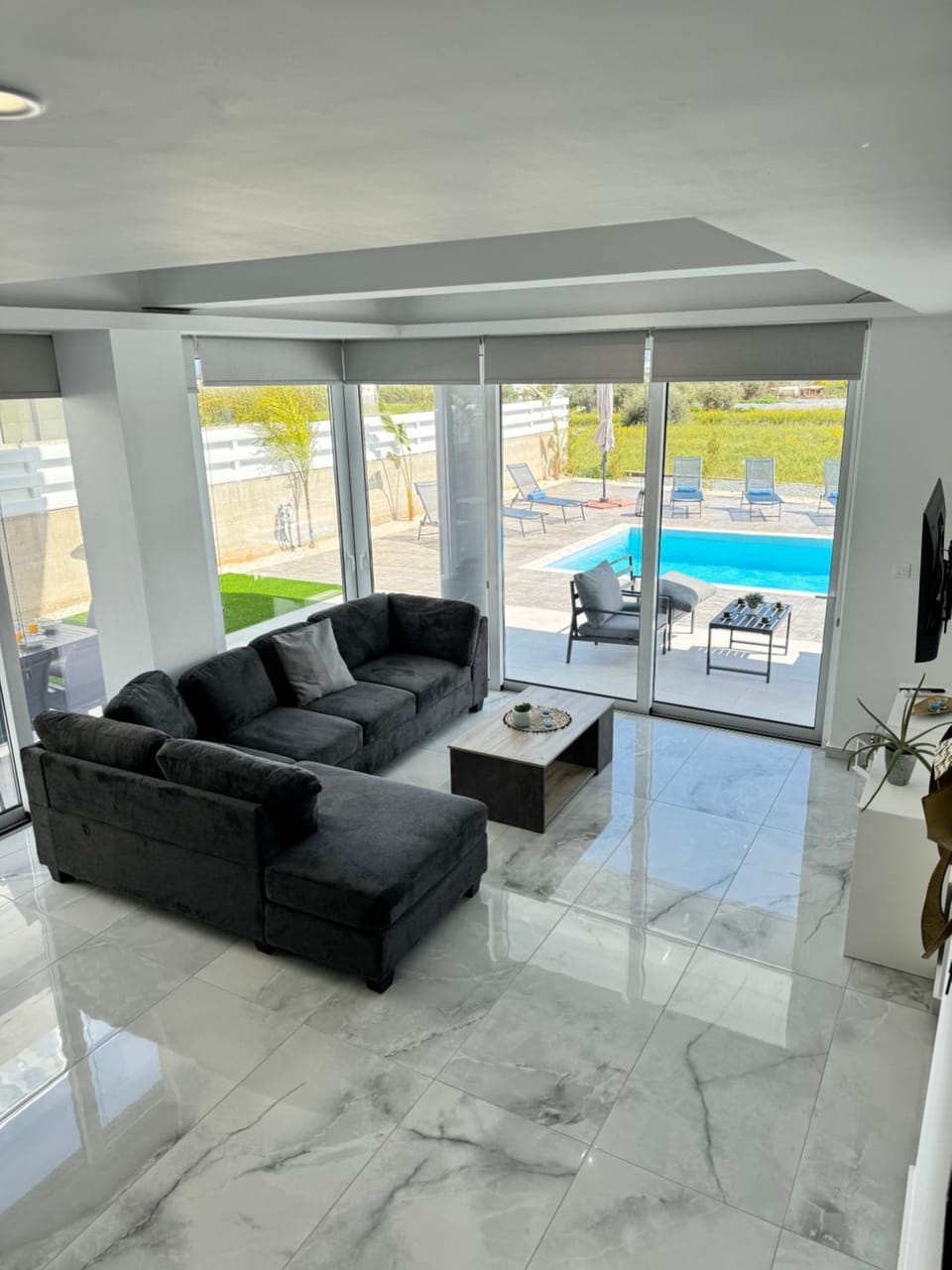 TV and multimedia, Living room, Seating area, Pool view, Time of day, Sunset