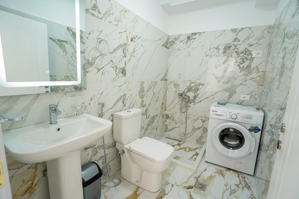 Toilet, towels, washing machine, dryer