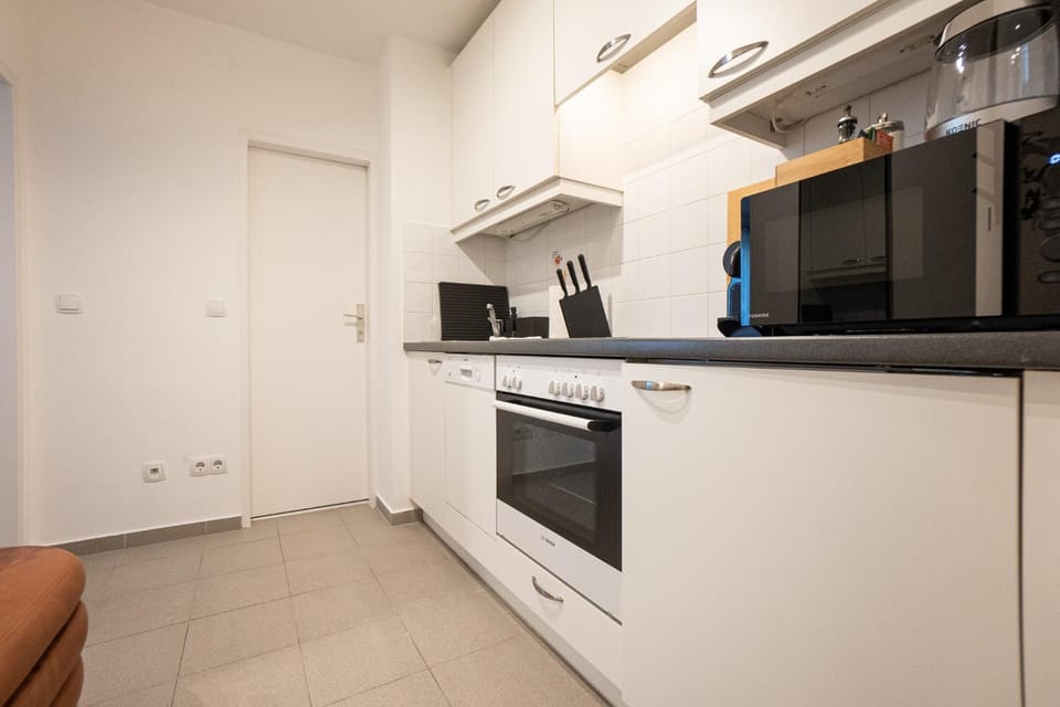 Kitchen or kitchenette, dishwasher, microwave, oven, stove