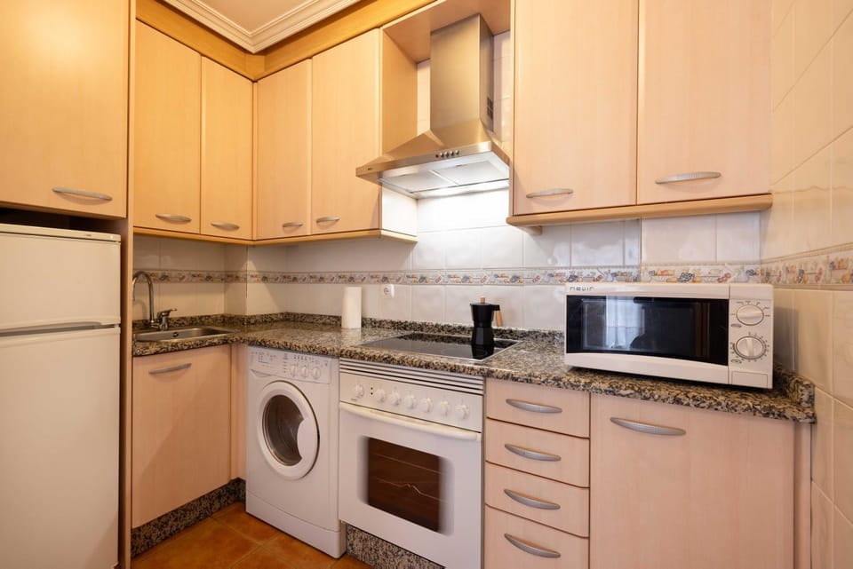 Kitchen or kitchenette, oven, stove, toaster, washing machine, dryer