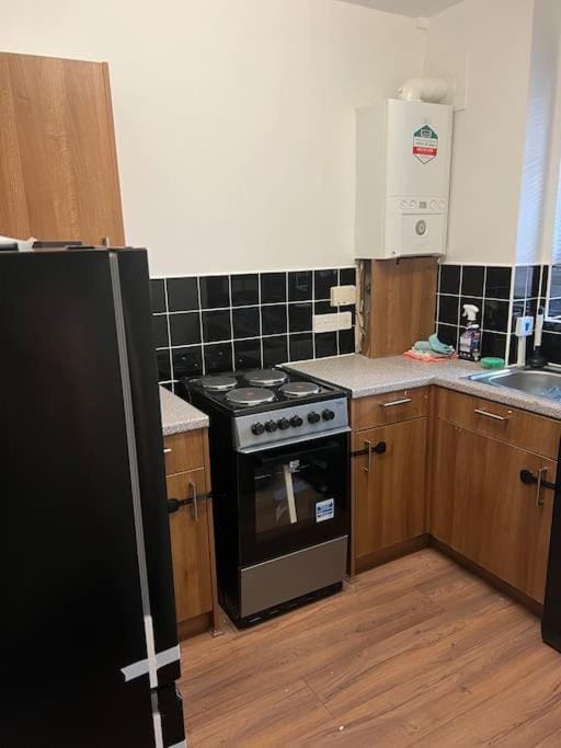 Kitchen or kitchenette, dishwasher, oven, stove