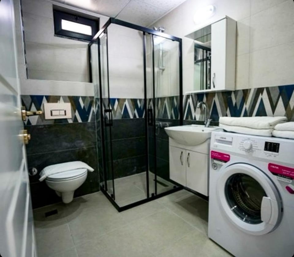 Shower, Toilet, Bathroom, towels, washing machine, dryer