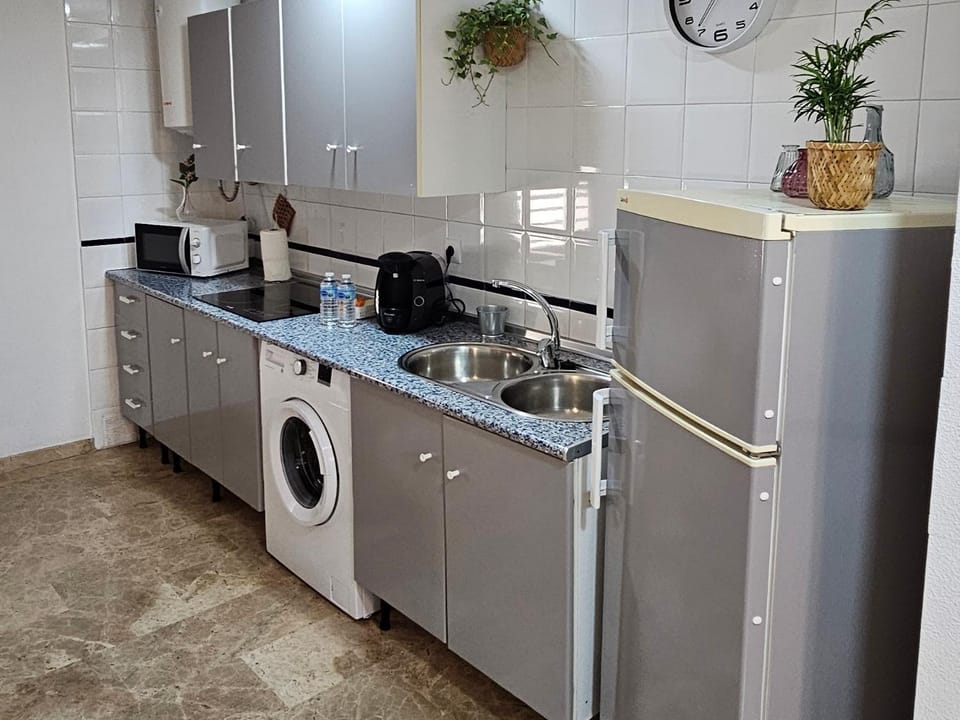 Kitchen or kitchenette, microwave, stove, washing machine