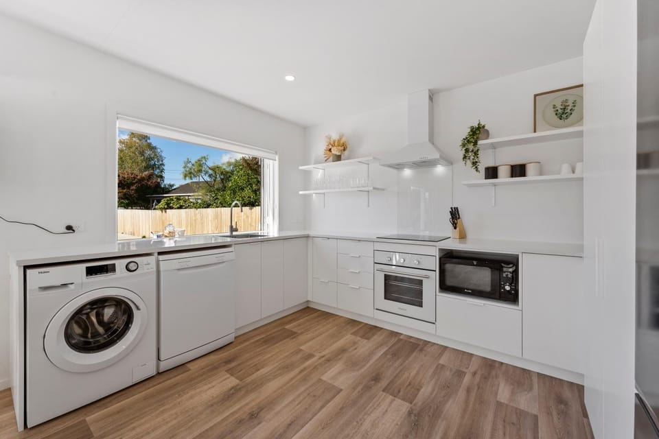 Kitchen or kitchenette, dishwasher, oven, stove, washing machine