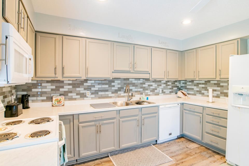 Kitchen or kitchenette, dishwasher, oven, stove