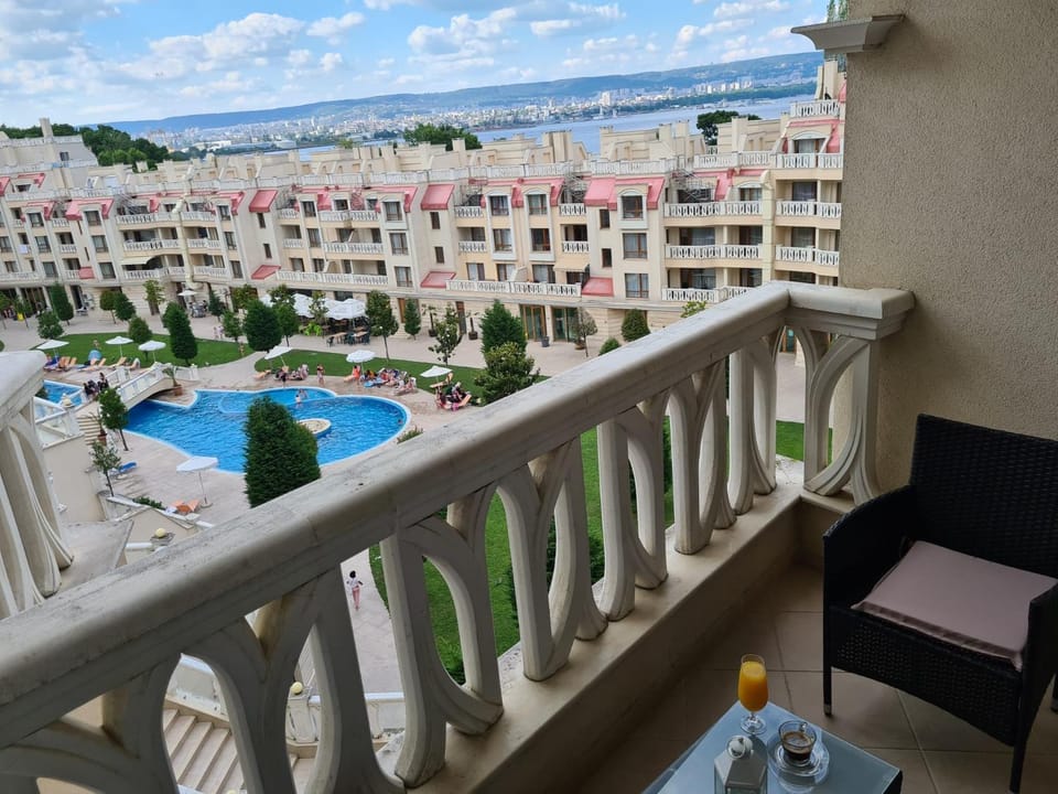 Property building, Patio, View (from property/room), Balcony/Terrace, Living room, Seating area, City view, Pool view, Sea view, Swimming pool, sunbed