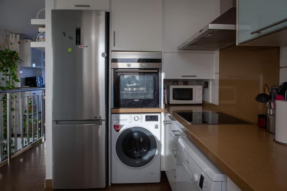 Kitchen or kitchenette, dishwasher, oven, stove, washing machine, dryer