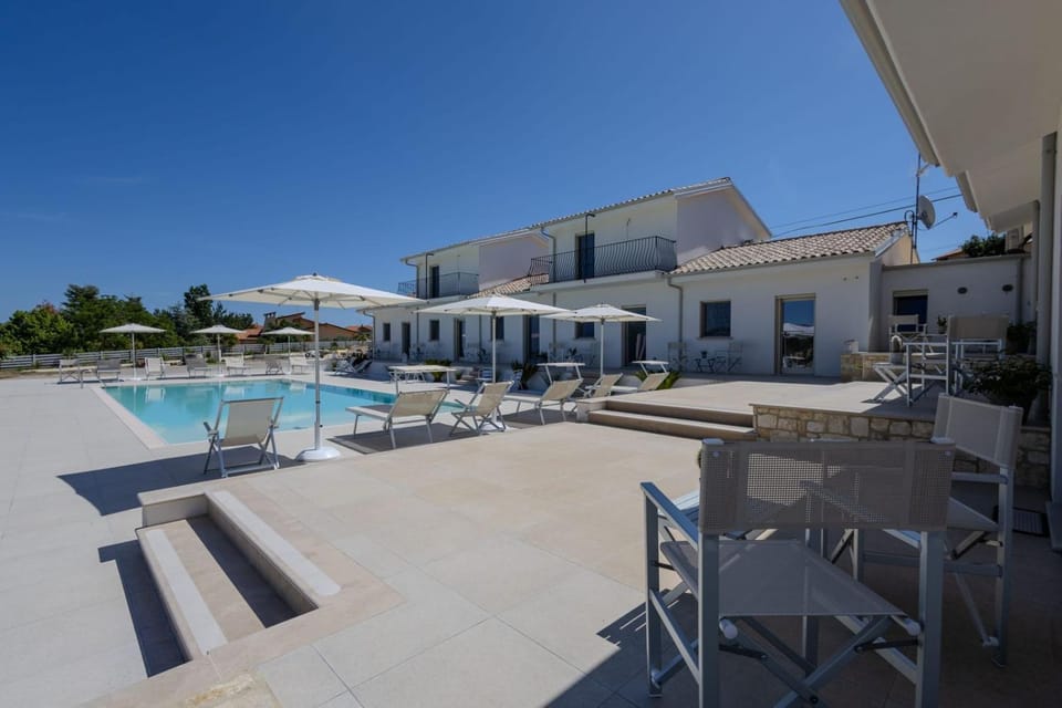 Property building, Patio, Pool view, Swimming pool, sunbed