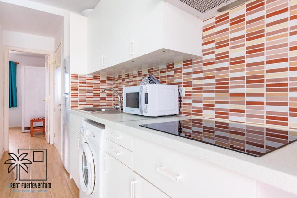 Kitchen or kitchenette, microwave, stove, toaster