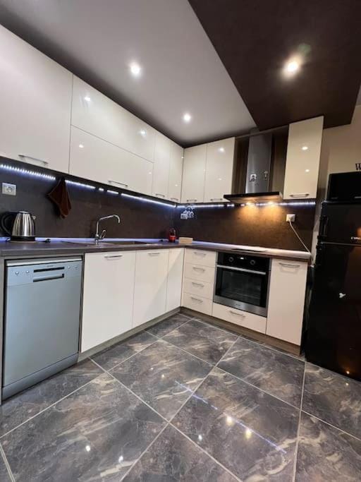 Kitchen or kitchenette, dishwasher, oven, stove