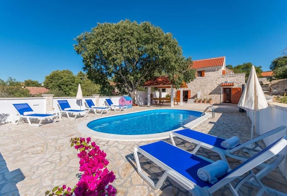 Patio, Day, Natural landscape, Pool view, Swimming pool, sunbed