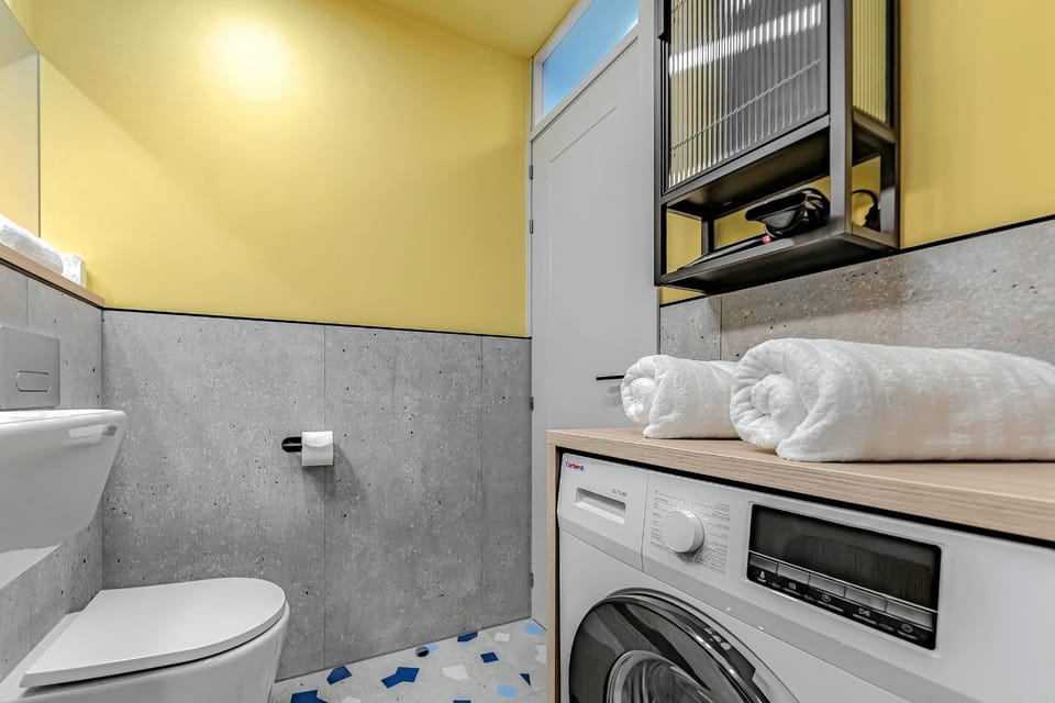 Toilet, towels, washing machine