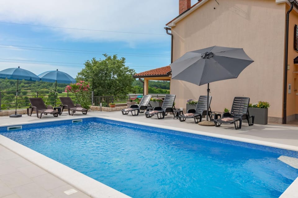 Property building, Patio, Day, Natural landscape, Pool view, Swimming pool, sunbed