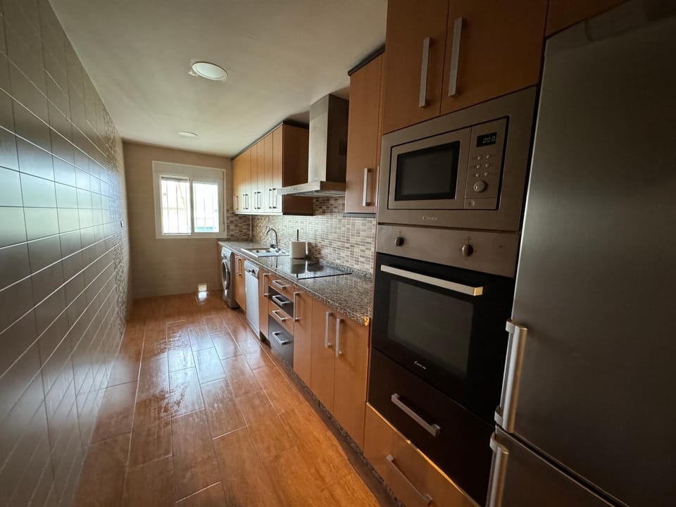 Kitchen or kitchenette, dishwasher, oven, stove