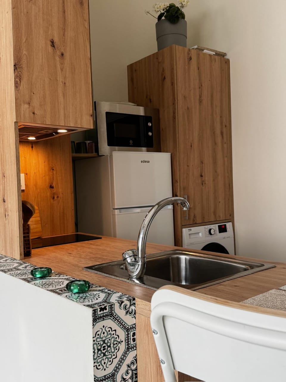 Kitchen or kitchenette, dishwasher, microwave, stove, washing machine