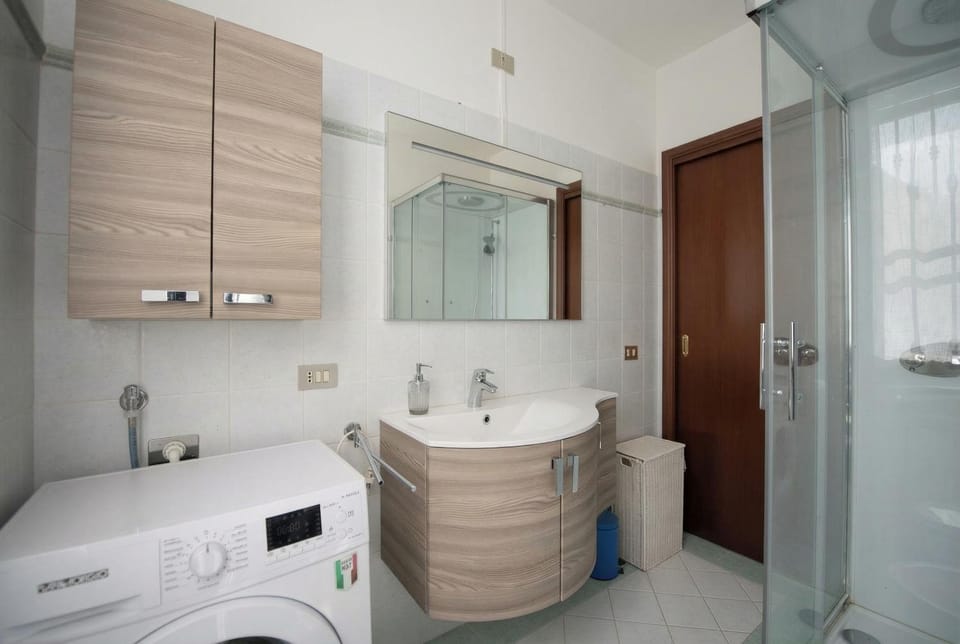 Shower, Bathroom, hair dryier, towels, washing machine