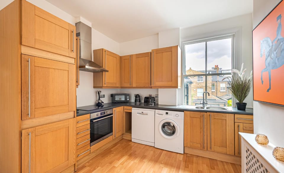 Kitchen or kitchenette, dishwasher, oven, stove, washing machine