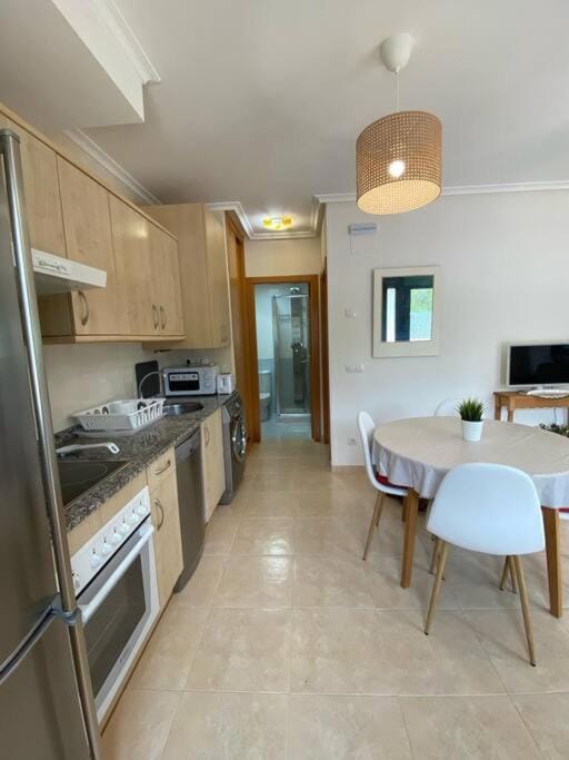 Kitchen or kitchenette, dishwasher, oven, stove