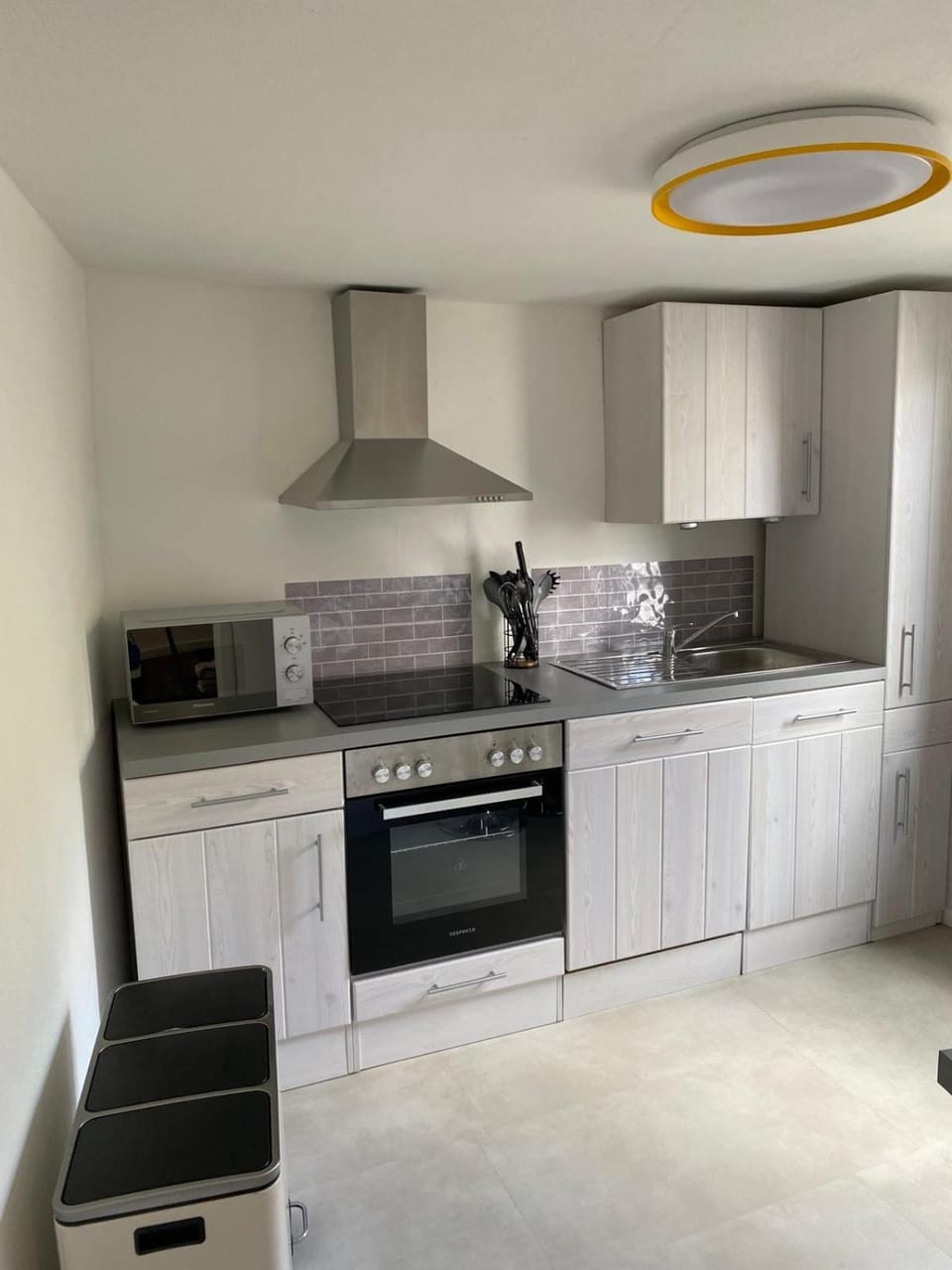 Kitchen or kitchenette, dishwasher, microwave, oven, stove
