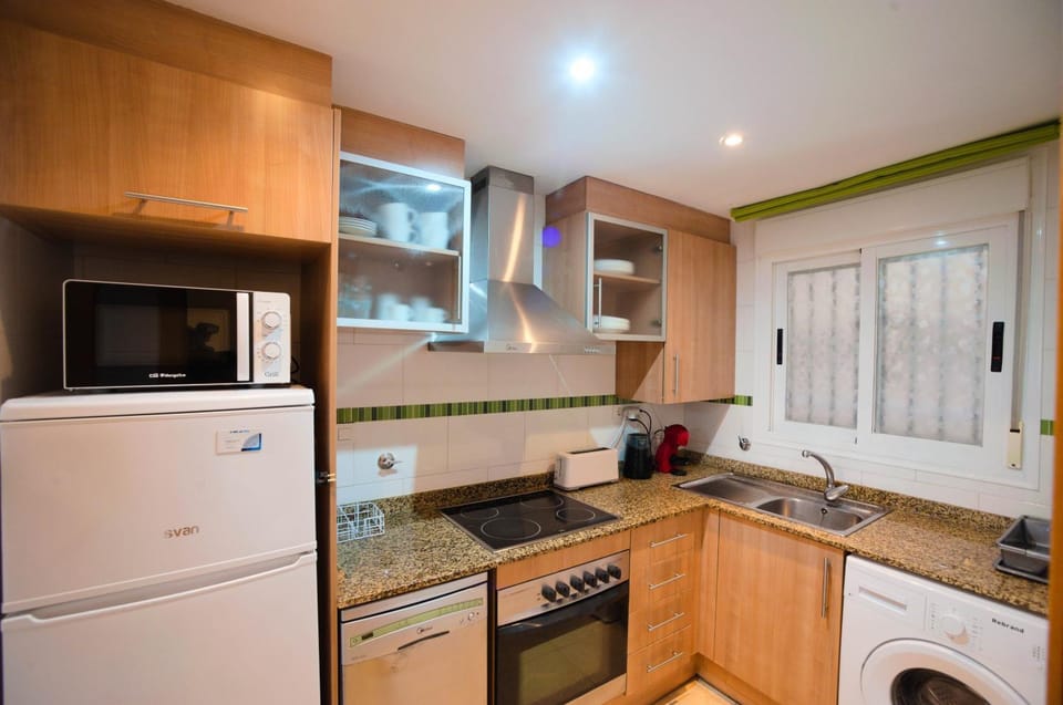 Kitchen or kitchenette, dishwasher, microwave, oven, stove, toaster, washing machine