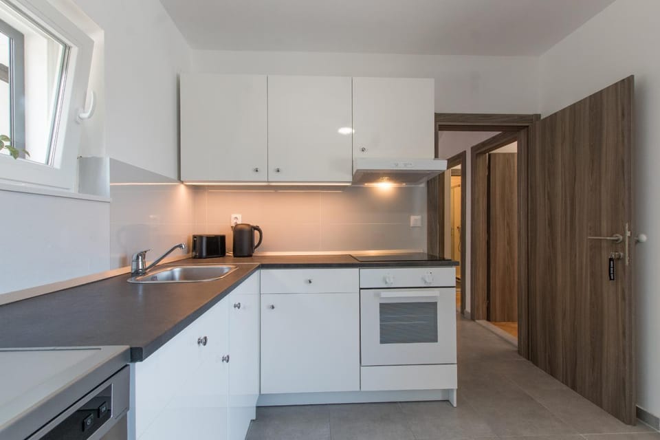 Kitchen or kitchenette, dishwasher, oven, stove