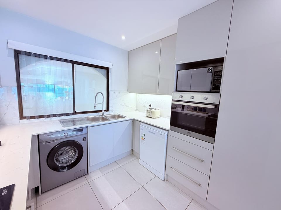 Kitchen or kitchenette, dishwasher, microwave, oven, stove, toaster, toaster, washing machine, dryer, kitchen, kitchen