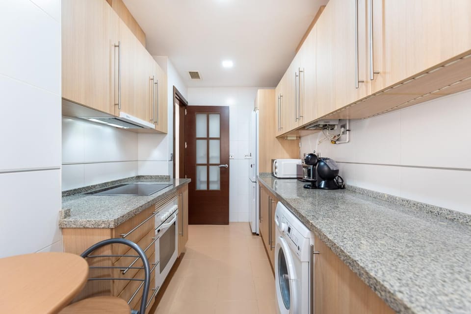 Kitchen or kitchenette, oven, stove, toaster, washing machine