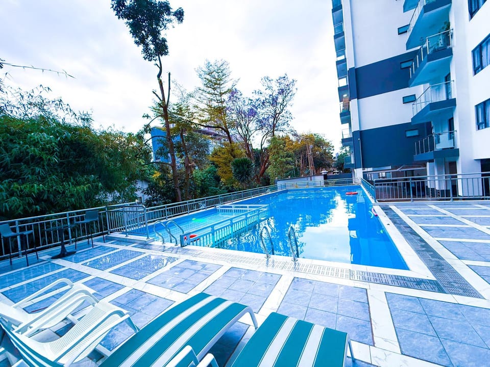 Property building, Day, Pool view, Swimming pool, sunbed