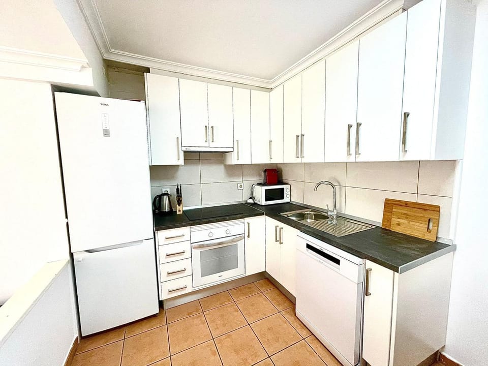Kitchen or kitchenette, dishwasher, oven, stove