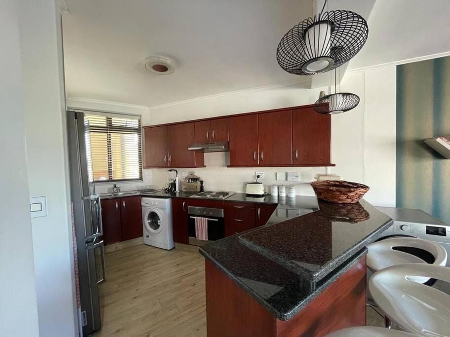 Kitchen or kitchenette, dishwasher, stove, washing machine, dryer