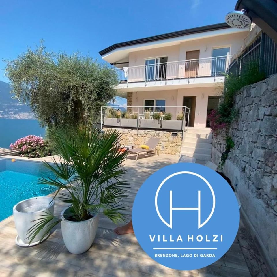 Property building, Patio, Day, Logo/Certificate/Sign, Lake view, Pool view, Swimming pool, sunbed