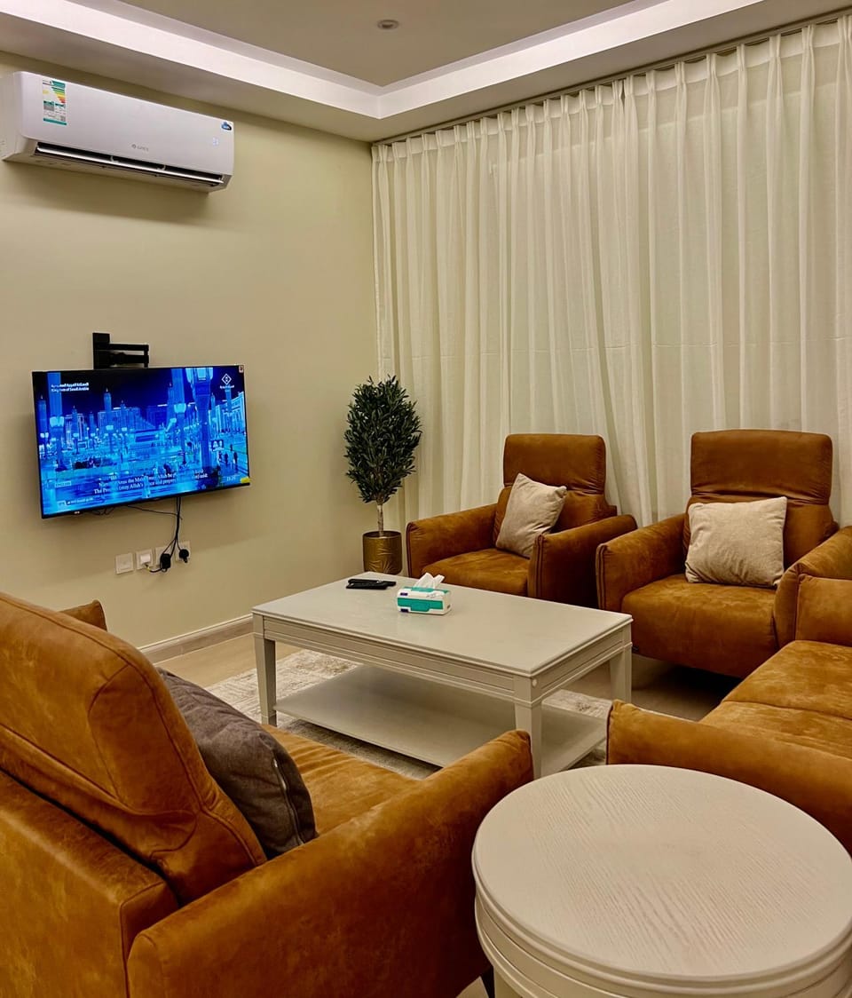 Property building, Property logo or sign, TV and multimedia, View (from property/room), Living room, Seating area, Evening entertainment, Family, kitchen, air conditioner