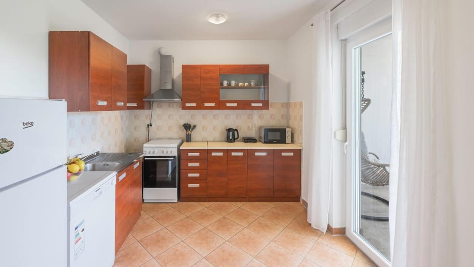 Kitchen or kitchenette, dishwasher, oven, stove, toaster