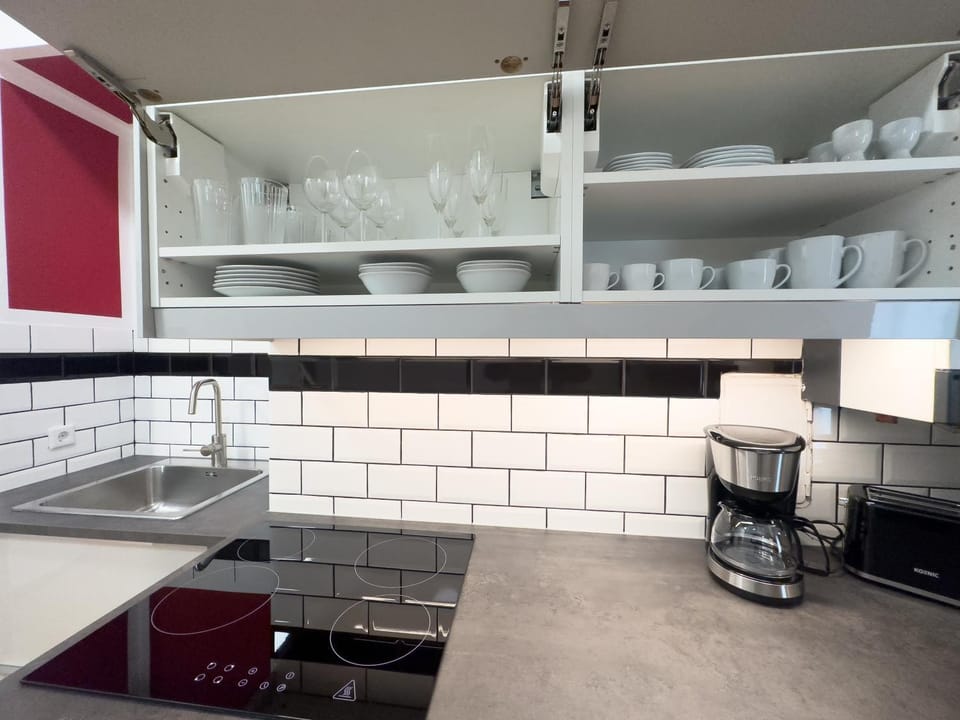 Kitchen or kitchenette, microwave, stove, toaster