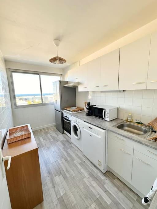 Kitchen or kitchenette, dishwasher, oven, stove, toaster, washing machine