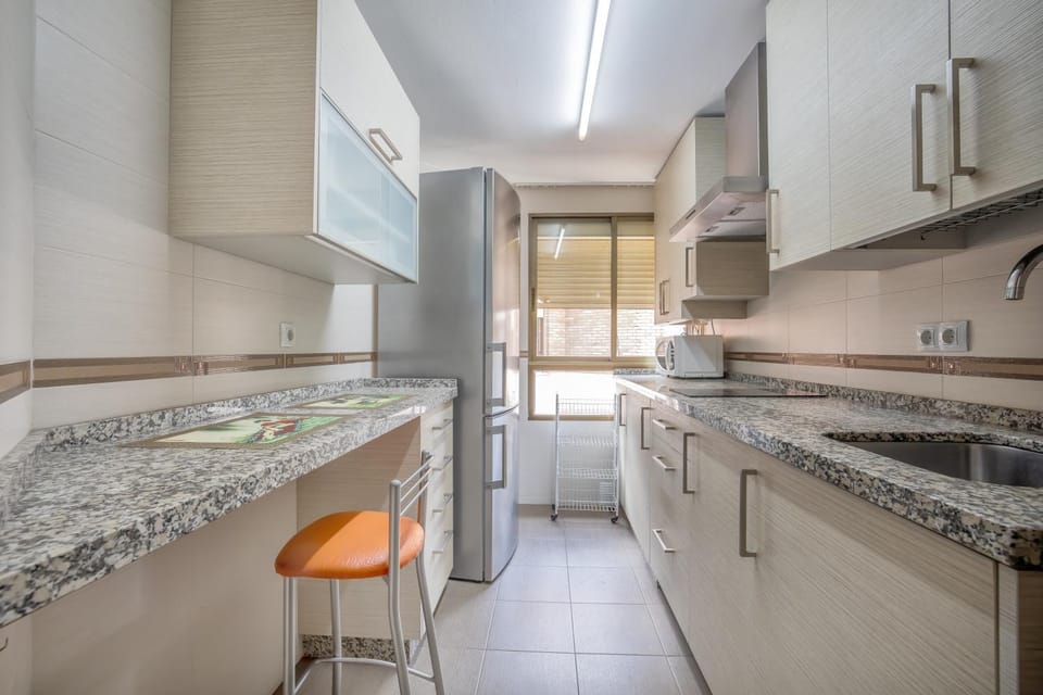 Kitchen or kitchenette, microwave, stove, washing machine