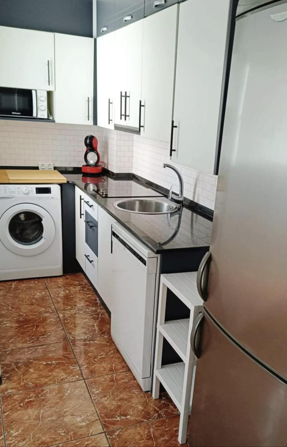 Kitchen or kitchenette, dishwasher, microwave, stove, washing machine