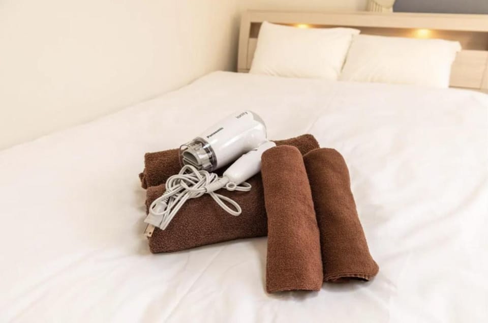 Bed, hair dryier, towels