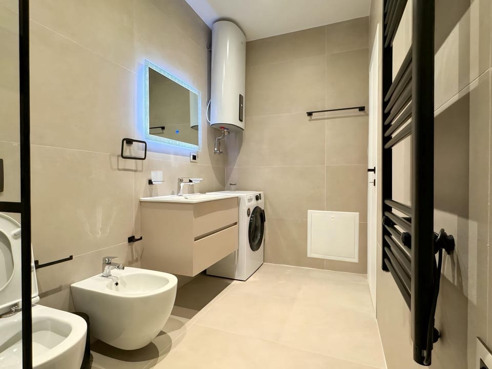 Shower, Toilet, Bathroom, Bath, bidet, towels, washing machine, dryer