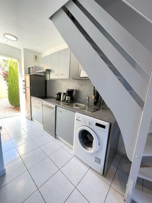 Kitchen or kitchenette, dishwasher, stove, washing machine, dryer
