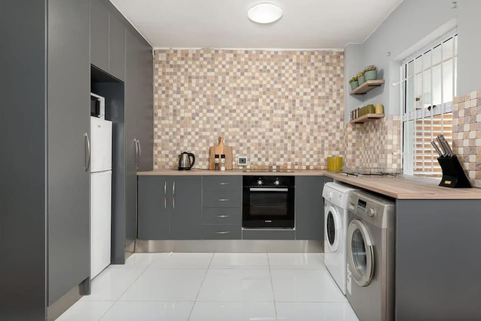 Kitchen or kitchenette, oven, stove, washing machine, dryer