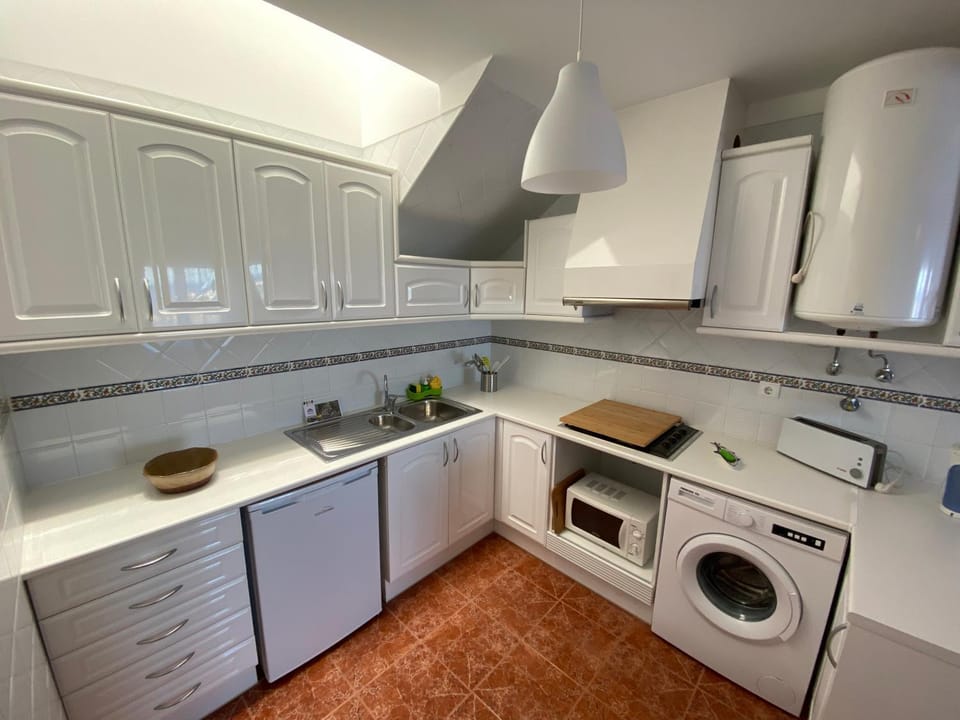 Kitchen or kitchenette, microwave, stove, washing machine
