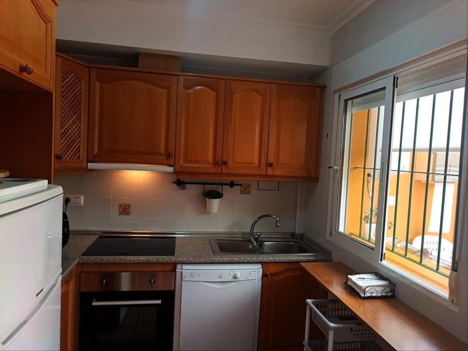 Kitchen or kitchenette, dishwasher, oven, stove