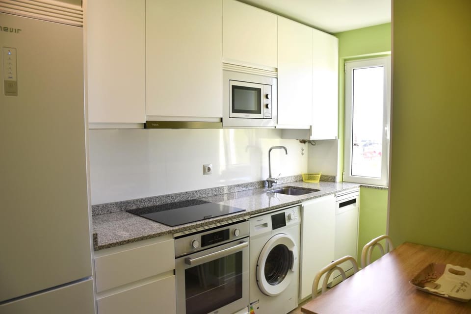 Kitchen or kitchenette, dishwasher, oven, stove, toaster, washing machine