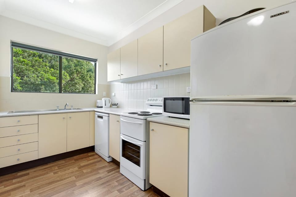 Kitchen or kitchenette, dishwasher, oven, stove